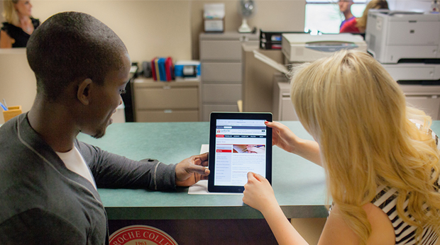 Staff and student surfing the website with an Ipad